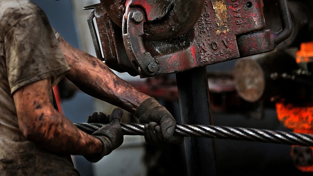 image of oil field worker covered in oil and wax